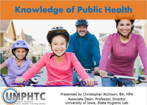 A family with young children riding bicycles and wearing helmets